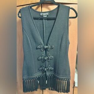 Andrea Jovine’s Black Sleeveless Vest with Decorative Frog Closures and Fringe.
